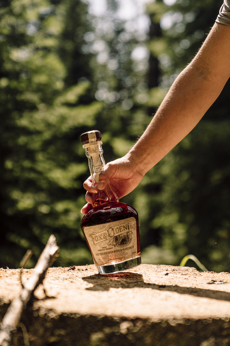 Fox & Oden Straight Bourbon on a fresh-cut stump